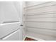 White pantry door opens to reveal white wire shelving over hardwood floors at 1307 Park Center Cir, Austell, GA 30168