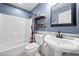 Bright bathroom with a shower/tub combo, decorative shelving and fixtures at 24 Scarlett Oak Ne Dr, Cartersville, GA 30121