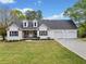 Charming home featuring a manicured lawn,dormer windows and a convenient three-car garage at 24 Scarlett Oak Ne Dr, Cartersville, GA 30121