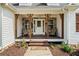 Inviting front porch with stone accents, ceiling fan, and cozy seating area at 24 Scarlett Oak Ne Dr, Cartersville, GA 30121