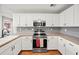Modern kitchen with stainless steel appliances and ample cabinet space at 24 Scarlett Oak Ne Dr, Cartersville, GA 30121