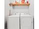 Bright laundry room with side-by-side washer and dryer and overhead storage shelf at 24 Scarlett Oak Ne Dr, Cartersville, GA 30121