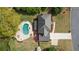 Aerial view of the home's roof, in-ground pool with patio, and a lush green backyard at 4455 Sirrocco Sw Ln, Lilburn, GA 30047
