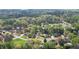 Aerial view of the neighborhood with tree-lined streets and a pool in the backyard at 4455 Sirrocco Sw Ln, Lilburn, GA 30047