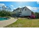 Spacious backyard with a screened porch, pool, and outdoor seating area at 4455 Sirrocco Sw Ln, Lilburn, GA 30047
