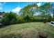 Expansive backyard with lush green grass and mature trees at 4455 Sirrocco Sw Ln, Lilburn, GA 30047