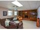 Basement living room features a brick fireplace, built-in shelving and a comfortable seating area at 4455 Sirrocco Sw Ln, Lilburn, GA 30047
