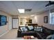 Finished basement with a comfortable seating area, projector screen, and access to storage at 4455 Sirrocco Sw Ln, Lilburn, GA 30047