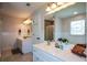 Bright bathroom features double sink vanity with white countertops, neutral walls and decorative mirror at 4455 Sirrocco Sw Ln, Lilburn, GA 30047