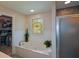 Luxurious bathroom boasts a stand alone tub, elegant window, walk-in closet, and glass shower door at 4455 Sirrocco Sw Ln, Lilburn, GA 30047
