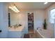 Bright bathroom with soaker tub, walk-in closet, vanity and abundant lighting at 4455 Sirrocco Sw Ln, Lilburn, GA 30047