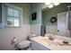 Clean bathroom with wainscoting and neutral color scheme at 4455 Sirrocco Sw Ln, Lilburn, GA 30047