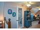 Bedroom hallway and bathroom with sloped ceiling, blue dresser, and lots of natural light at 4455 Sirrocco Sw Ln, Lilburn, GA 30047