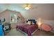 Charming bedroom featuring a sloped ceiling, desk, and cozy seating area at 4455 Sirrocco Sw Ln, Lilburn, GA 30047
