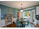 Cozy breakfast nook with bay window, round table, and charming decor at 4455 Sirrocco Sw Ln, Lilburn, GA 30047