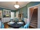 Cozy dining space showcasing wainscoting, stairs, and a stairway entry at 4455 Sirrocco Sw Ln, Lilburn, GA 30047