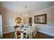 Traditional dining room with chandelier, hardwood floors, and decorative accents at 4455 Sirrocco Sw Ln, Lilburn, GA 30047