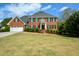 Beautiful two-story brick home with a well-manicured lawn and attached two car garage at 4455 Sirrocco Sw Ln, Lilburn, GA 30047