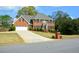 Inviting two-story brick house featuring a well-maintained front yard and long driveway at 4455 Sirrocco Sw Ln, Lilburn, GA 30047