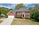 Traditional brick home with a well-manicured lawn and attached two-car garage at 4455 Sirrocco Sw Ln, Lilburn, GA 30047