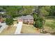Beautiful red brick two-story home with black shutters and a long drive and mature landscaping at 4455 Sirrocco Sw Ln, Lilburn, GA 30047