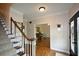Bright foyer featuring elegant hardwood floors and a staircase with classic wood banister at 4455 Sirrocco Sw Ln, Lilburn, GA 30047