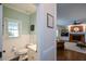 Half bath with wainscoting detail, adjacent to the living room at 4455 Sirrocco Sw Ln, Lilburn, GA 30047