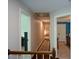 Hallway with wood floors and doors to bedrooms, filled with natural light at 4455 Sirrocco Sw Ln, Lilburn, GA 30047