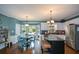 Bright eat-in kitchen with stainless steel appliances and an island, open to the dining area at 4455 Sirrocco Sw Ln, Lilburn, GA 30047