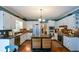 Spacious kitchen features white cabinets, stainless steel appliances, and a center island at 4455 Sirrocco Sw Ln, Lilburn, GA 30047