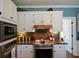 Well-equipped kitchen showcasing stainless steel appliances and ample cabinet space at 4455 Sirrocco Sw Ln, Lilburn, GA 30047
