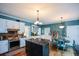Open kitchen featuring stainless steel appliances, a central island, and adjacent dining area at 4455 Sirrocco Sw Ln, Lilburn, GA 30047