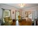 Classic living room featuring hardwood floors, matching arm chairs, and bright natural light at 4455 Sirrocco Sw Ln, Lilburn, GA 30047