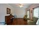 Elegant living room featuring hardwood floors, ceiling fan, and large windows with sheer curtains at 4455 Sirrocco Sw Ln, Lilburn, GA 30047