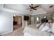 Spacious bedroom features a tray ceiling, ceiling fan, and convenient access to other rooms at 4455 Sirrocco Sw Ln, Lilburn, GA 30047