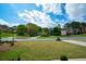 Picture perfect neighborhood street with a manicured lawn and an elegant residence at 4455 Sirrocco Sw Ln, Lilburn, GA 30047