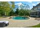 Resort-style pool and spa with lush greenery and a nearby screened porch at 4455 Sirrocco Sw Ln, Lilburn, GA 30047