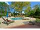 Stunning pool and spa with stone accents and outdoor lounge area at 4455 Sirrocco Sw Ln, Lilburn, GA 30047