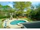 Aerial view of landscaped backyard features large in-ground pool, seating and fireplace at 4455 Sirrocco Sw Ln, Lilburn, GA 30047
