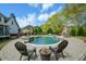 Beautiful pool area with a hot tub, stone features, and outdoor seating at 4455 Sirrocco Sw Ln, Lilburn, GA 30047