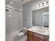 Bathroom features a vanity with one sink, a tub, a shower with tile surround, and a window at 1016 Manchester Way # 43, Roswell, GA 30075