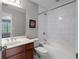 A bathroom featuring a vanity with one sink, a tub, a shower with tile surround, and a window at 1016 Manchester Way # 43, Roswell, GA 30075