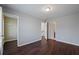 A bedroom with hardwood floors and doors leading to a bathroom and closet space at 1016 Manchester Way # 43, Roswell, GA 30075