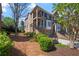 Charming multi-story townhome featuring stone and brick facade, small balconies and landscaped front yard at 1016 Manchester Way # 43, Roswell, GA 30075