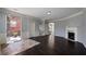 Open-concept living room features hardwood floors, fireplace, and easy access to an outdoor balcony at 1016 Manchester Way # 43, Roswell, GA 30075
