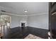 Cozy living room with dark hardwood floors, fireplace, and open floor plan to the kitchen at 1016 Manchester Way # 43, Roswell, GA 30075
