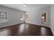 Bright room with hardwood floors, two windows, and a glass door leading to the outside at 1016 Manchester Way # 43, Roswell, GA 30075