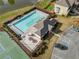 Aerial view of community pool, clubhouse, tennis courts, parking, pond, and landscaped grounds at 4454 Kentland Dr, Acworth, GA 30101