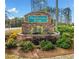 Community entrance sign 'Huddlestone Bridge' surrounded by colorful landscaping and greenery at 4454 Kentland Dr, Acworth, GA 30101
