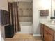 Bathroom with granite countertops, a bathtub with tile surround, and brown accents at 5449 Festival Ave, Fairburn, GA 30213